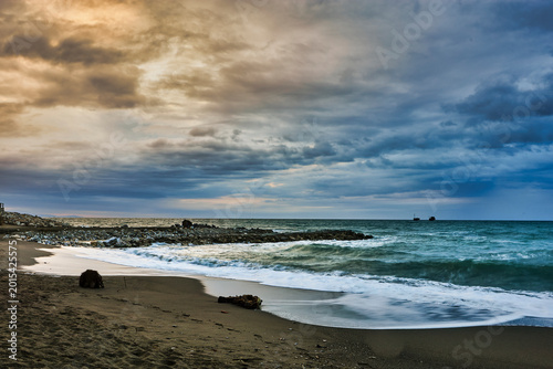 Storm clouds gathering over a dramatic beach seascape