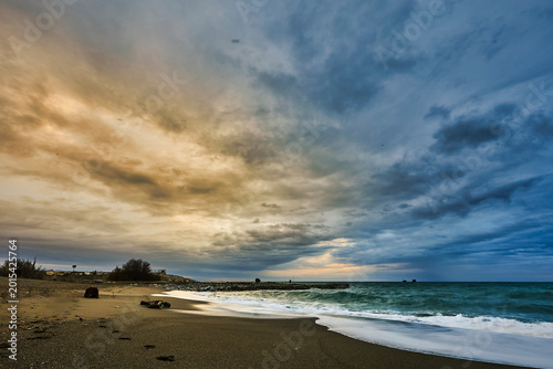 Dramatic coastal landscape with dark stormy sky