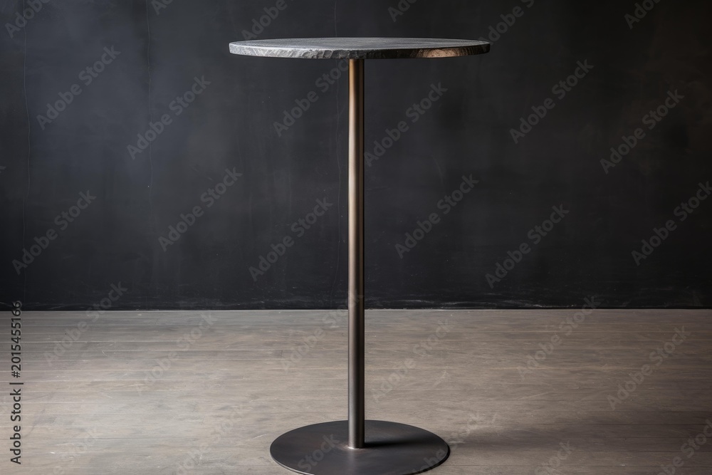 Fototapeta premium Industrial standing table with a dark stone surface and metal base