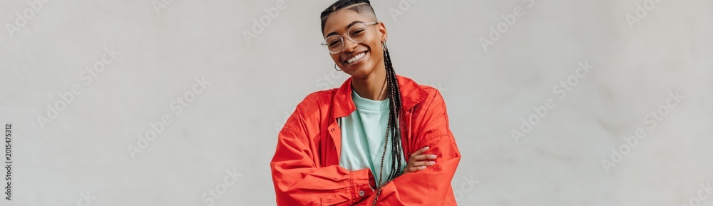 © Andrii Zastrozhnov - Young woman smiling with crossed arms in neutral studio backdrop © Andrii Zastrozhnov - Young woman smiling with crossed arms in neutral studio backdrop