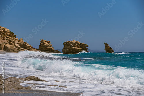 Tableau sur toile Landscape with waves crashing against characteristic rocks on Triopetra Beach on