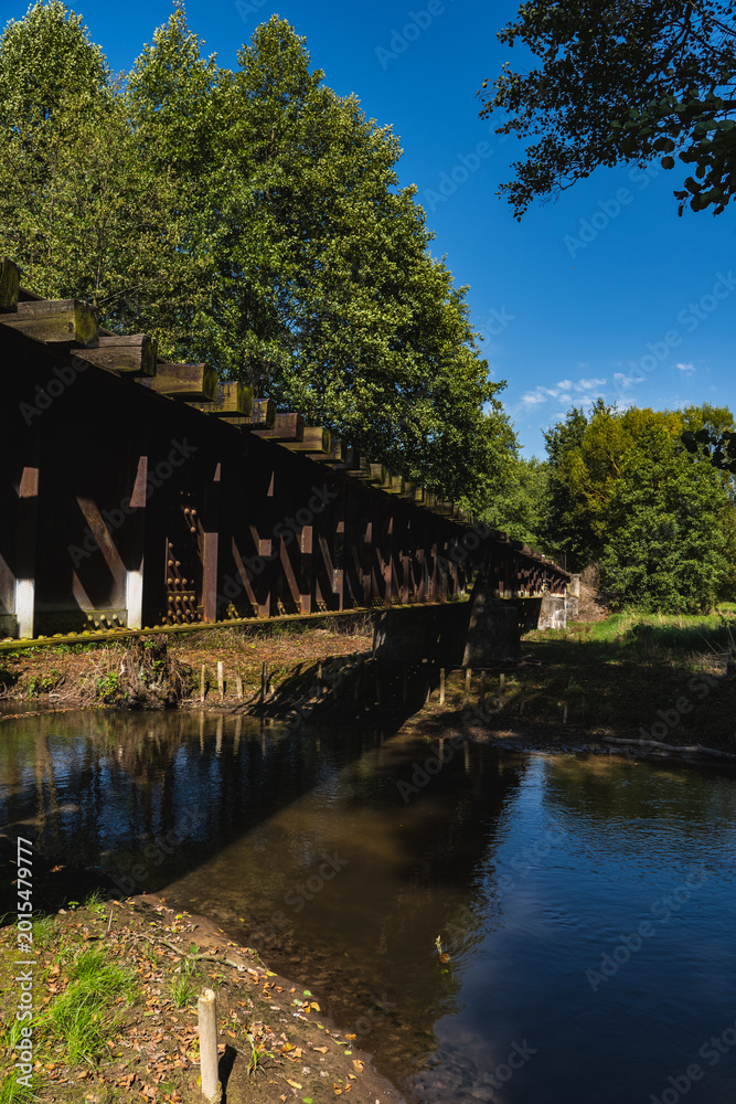 Fototapeta premium landscape with an old steel railway bridge crossing the river