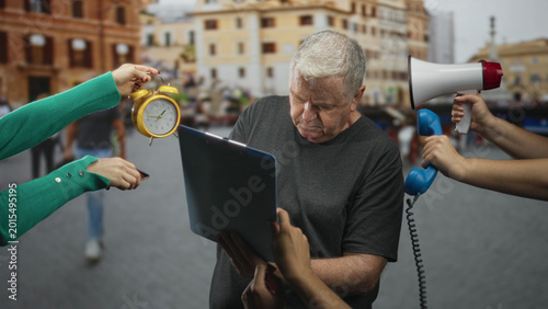 Foto Man holding clipboard and recoiling from a megaphone while hands offer alarm clock and phone on a busy street; frustration urgency