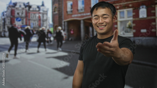 Obraz na płótnie Man extends hand for handshake on a busy city street with blurred pedestrians behind him; friendship