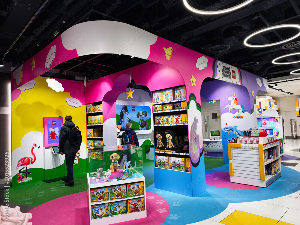 Fototapeta premium Colorful LEGO toy store display in London UK with children playing and family shoppers in a vibrant kids retail area full of toys and interactive exhibits