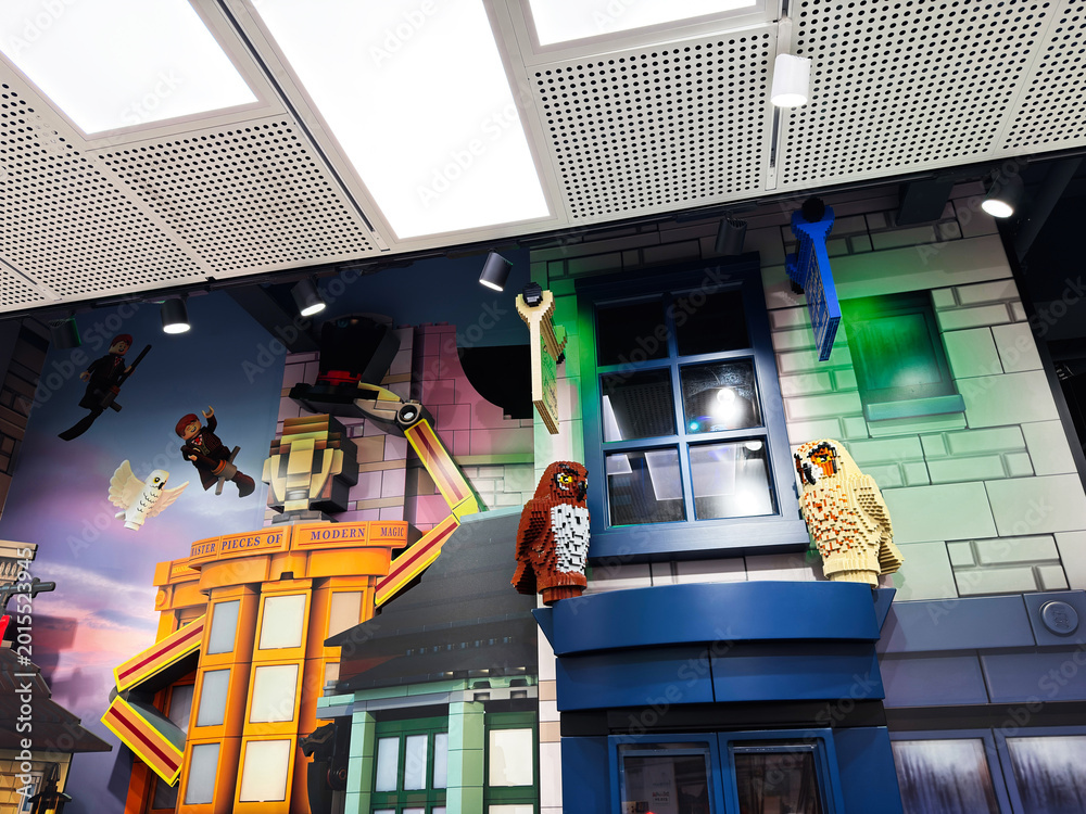 Fototapeta premium Colorful LEGO owl and wizard shop display in a London UK toy store window made of giant bricks and playful figures lighting up a family friendly retail experience