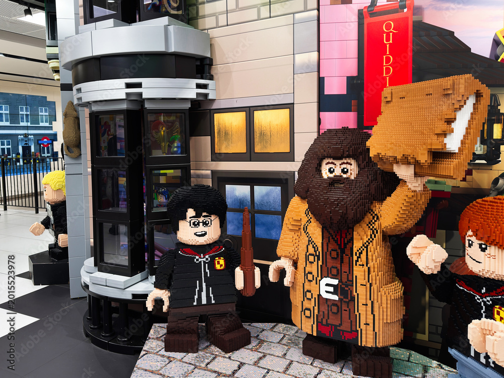 Obraz premium Lego Harry Potter display featuring Hagrid holding a suitcase beside Harry and Ron in a shopping centre in London, UK