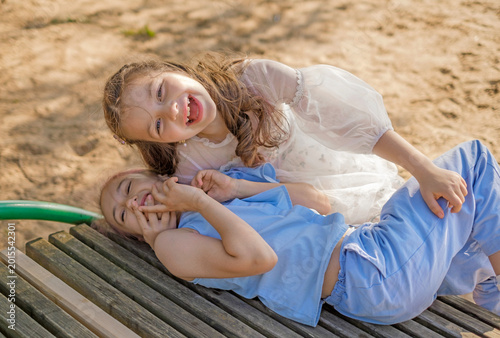 Bilde på lerret The girls frolic and hug, making fun of each other