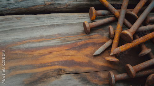 Rusted iron nails scattered on weathered wood planks close up texture high-quality professional detailed modern elegant stylish clean crisp vibrant
