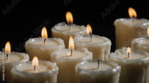 Group of Burning Candles Glowing in the Dark