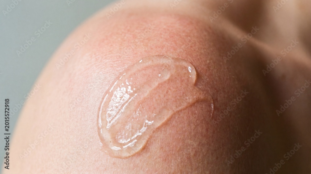 Fototapeta premium Close-up of gel applied on skin for hydration, showcasing skincare routine for moisture retention and healthy dermis care.