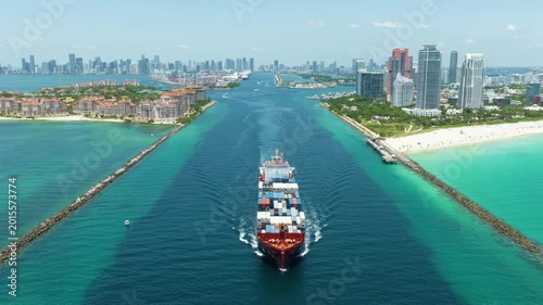 Miami, Florida, USA - May 16, 2025: Cargo ship loaded with container in Miami, aerial. Freight container, copy space. Aerial Miami port with cargo container. Export and import. Port of Miami