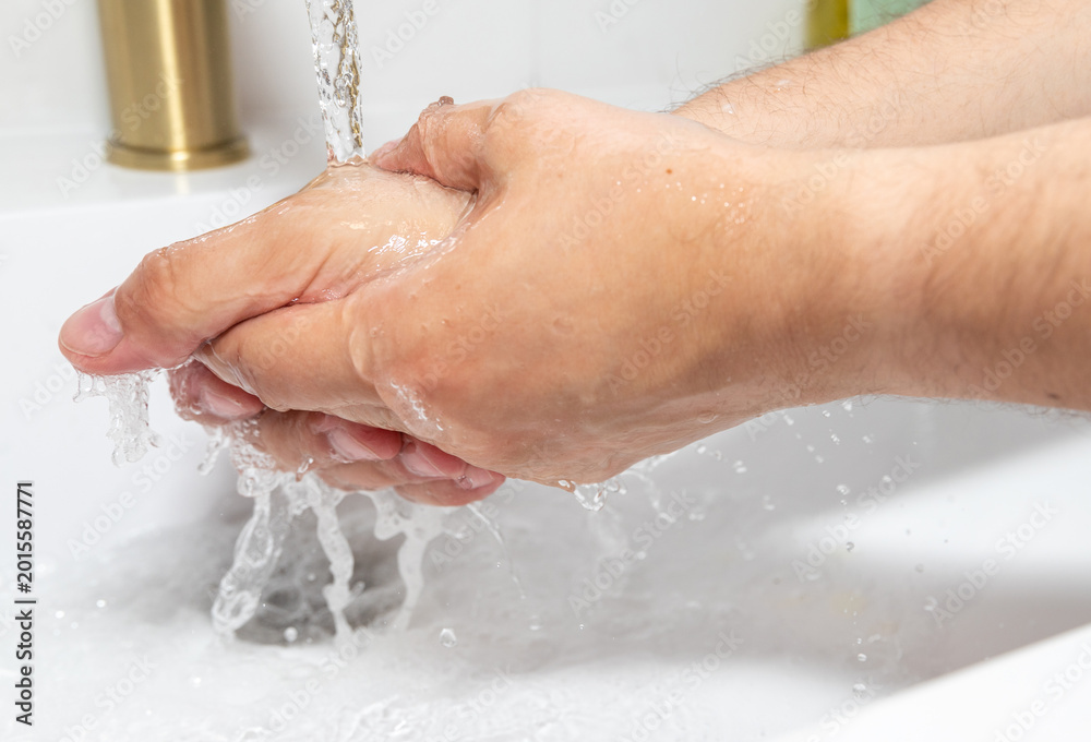 Fototapeta premium Washing Hands Under Running Water in Bathroom Sink