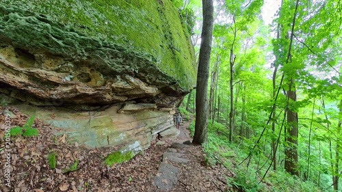 Man Hikes Below Rock Overhangs in New River Gorge National Park