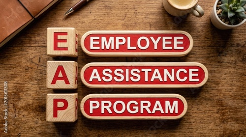 Wooden blocks displaying the acronym eap next to labels that clearly spell out employee assistance program on wooden table
