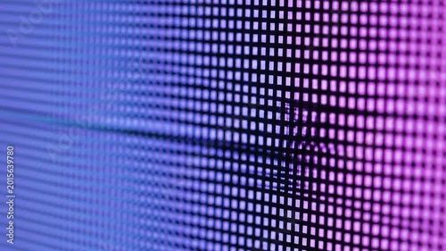 High angle view of an electronic screen display showing an abstract matrix grid of blue and violet light pixels.