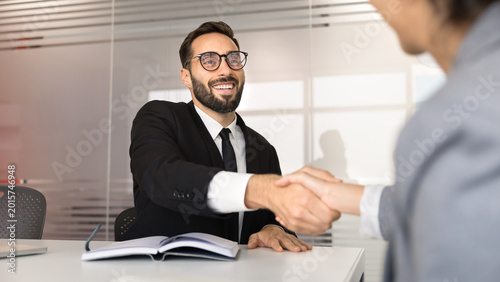 Tableau sur toile Businessman handshake with corporate client or business partner, closing deal, confirming agreement in office