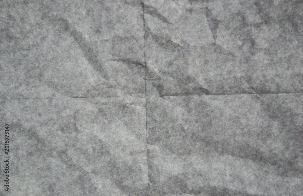 Obraz premium Dark crumpled paper texture with visible fold marks, distressed wrinkles and grunge surface. Abstract paper background with aged dirty texture, creased sheet effect.