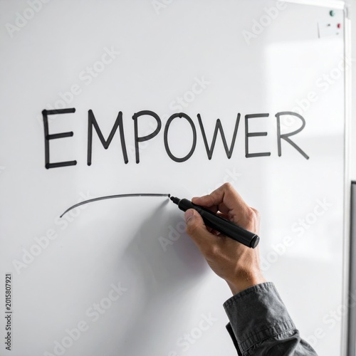 hand writing empower on white board with black marker, leadership training, business strategy, professional development, motivational message for teamwork