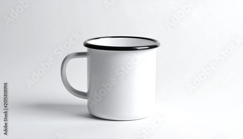 A simple, white, cylindrical coffee mug with a black rim and a single gray handle stands isolated against a neutral background