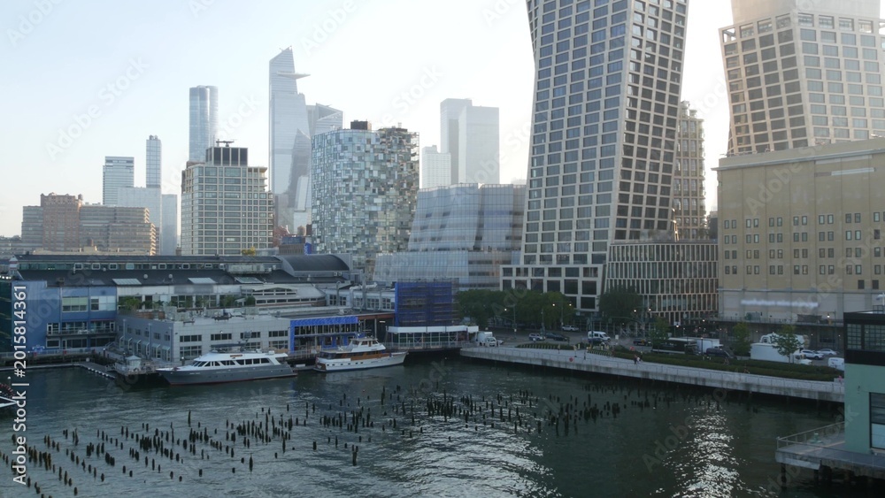 Obraz premium New York City Hudson yards and Chelsea urban view from Little Island pier park, Midtown of Manhattan, United States. Waterfront building architecture, skyline cityscape in USA, NYC west side district.