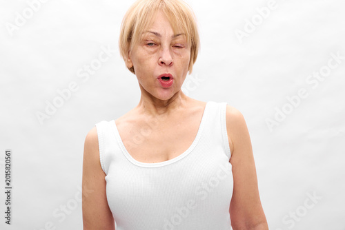 Bild auf Leinwand Woman blonde surprised mouth open tanktop white studio expression, older adult s