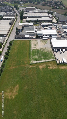Aerial view of industrial park: A high-angle perspective showcasing a sprawling industrial park, where the harmonious blend of architecture, industry and nature is evident from the sky.
