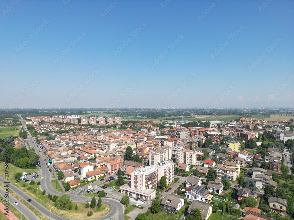 Fototapeta premium Urban Panorama: Aerial view of a charming town, captured on a sunny day. The scene showcases a tapestry of architecture and infrastructure, inviting exploration.