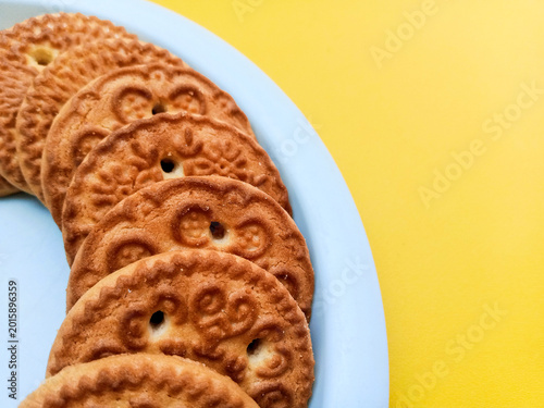 Golden Brown Biscuits Top View on Vibrant Yellow Background
