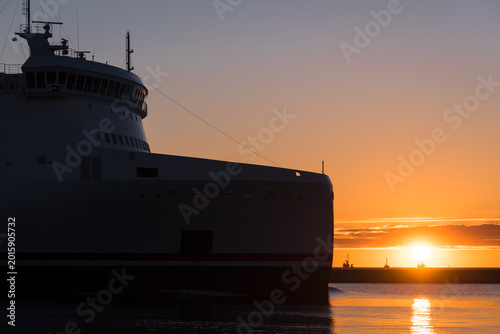 Fotografie MARITIME TRANSPORT - Passenger-Car ferry sailing to the seaport on the sunrise b