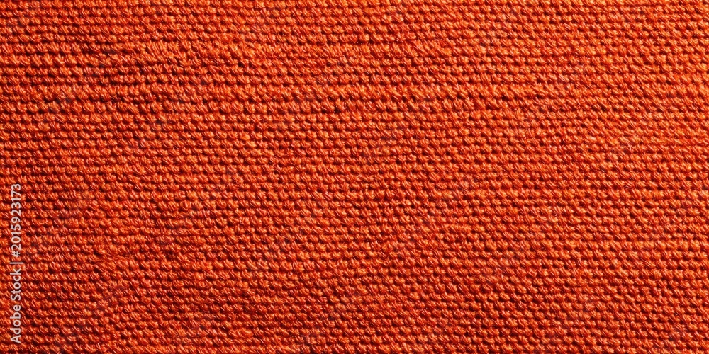 Fototapeta premium Close-up textured weave of a tightly woven, rough orange fabric