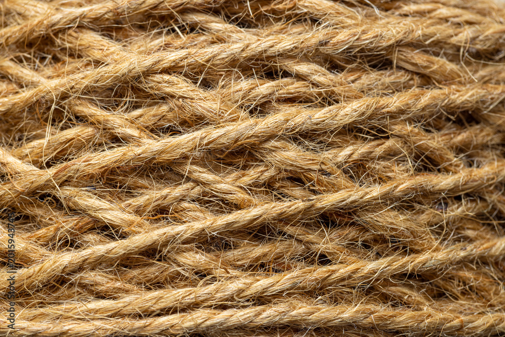Fototapeta premium Extreme close-up of natural jute rope texture background,Macro,A detailed macro shot showing the intricate texture and fibrous strands of a coiled natural jute rope. The warm brown tones and organic.