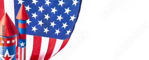 Fourth of July USA Independence Day festive celebration concept with copy space. Handmade craft paper rockets decorated with stars and stripes, USA flag, white background.
