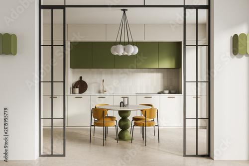 Photos Modern kitchen interior with minimalist white cabinetry, green upper units, elegant dining set and metal framed partition creating a clean spacious atmosphere