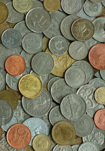Heap of colorful coins from different countries, macro photography. International currency