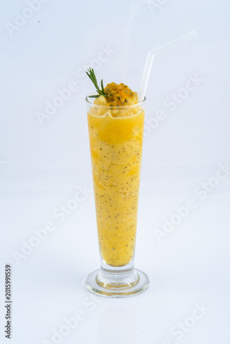 Passion fruit smoothie with rosemary garnish in a tall glass