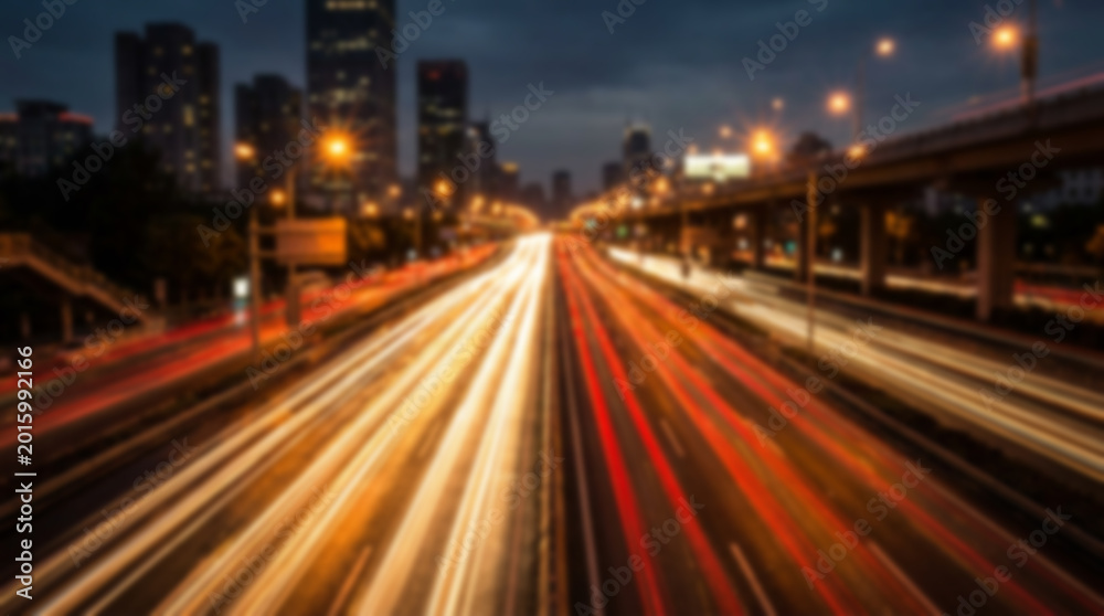 Obraz premium City highway at night with light trails from cars, motion blur effect, urban landscape