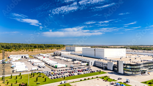 Schilderij op canvas Aerial view of modern industrial warehouse and logistics center