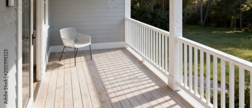 Scandinavian front porch with a modern chair and sunlight casting shadows on the deck