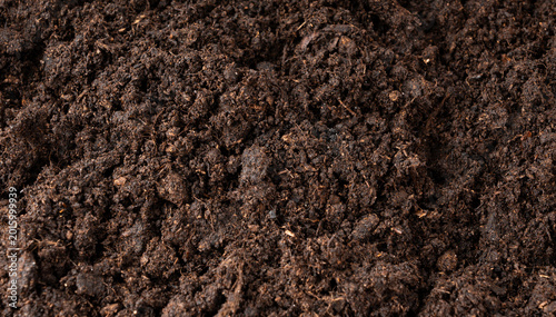 Peat soil textured background. Compost pile, brown garden dirt mound
