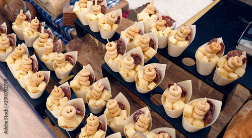 Quadro em tela Traditional Italian appetizers in paper cones displayed during Aromatica festival