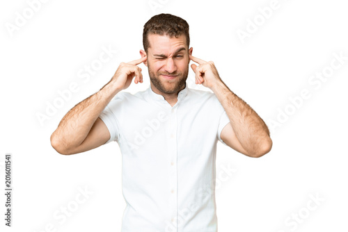 Fotografia Young handsome blonde man over isolated chroma key background frustrated and cov