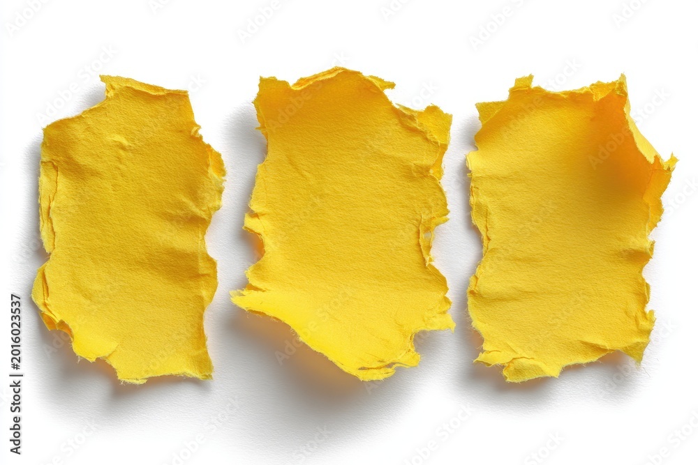 Naklejka premium Three torn bright yellow textured paper scraps on a white background