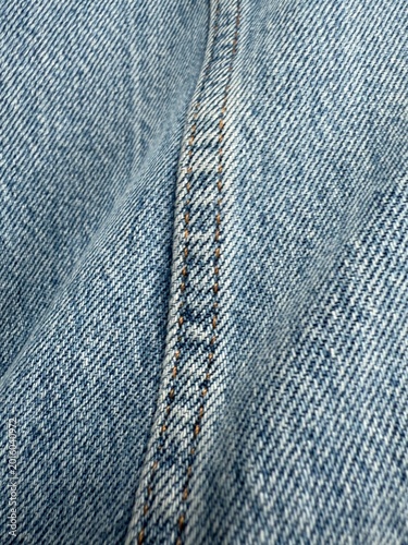 Schilderij op canvas Close-up of blue denim fabric seam with detailed stitching texture, ideal for ba