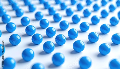 A striking abstract composition features numerous vibrant blue spheres arranged in a repeating pattern across a clean, white surface, creating a visually compelling and symmetrical design.