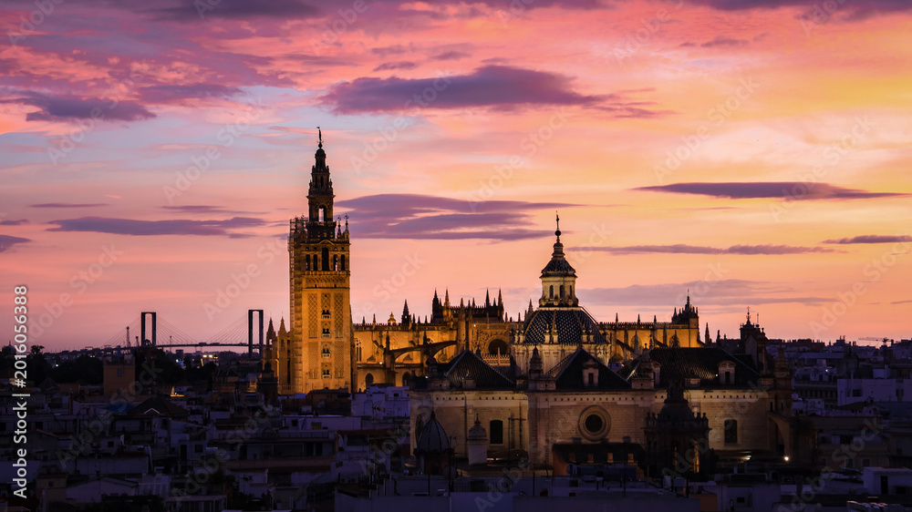 Naklejka premium The Sunset Glow over the Seville Cathedral and Giralda Tower