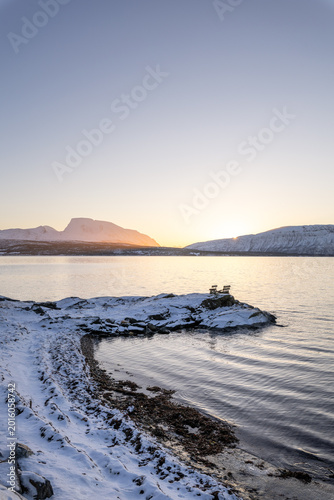 Minimal Arctic sunset over frozen Malangen Fjord