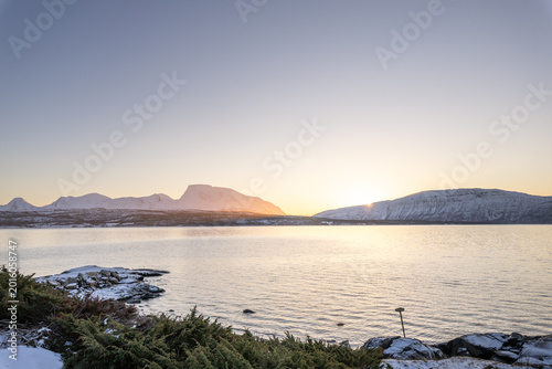 Minimal Arctic sunset over frozen Malangen Fjord