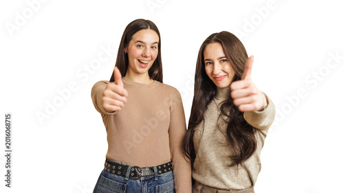 Two smiling women standing together confidently, giving a thumbs up gesture, symbolizing success, approval, and happiness with transparent background