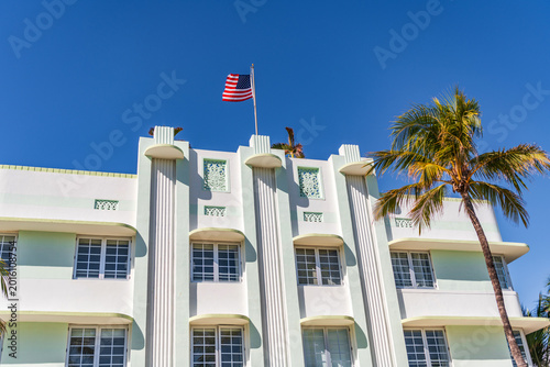 Modern building of Miami beach with USA flag. Ocean drive. Miami Beach in Ocean Drive, USA. Art Deco building architecture. Architectural building. Art deco. Architectural district Art Deco